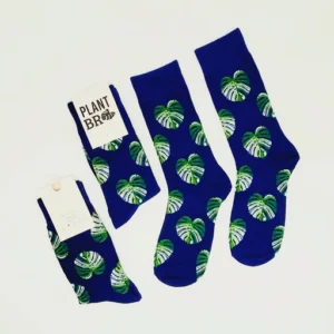 A pair of socks with green leaves on them.